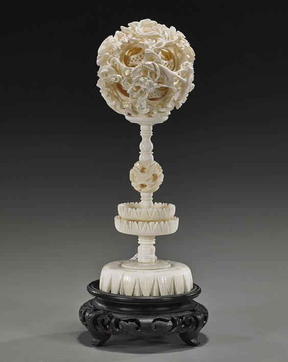 Chinese Carved Ivory Puzzle Ball on Stand: Chinese Carved Ivory Puzzle Ball on Stand Chinese carved ivory puzzle ball: with elaborate openwork design of writhing dragons among clouds on the exterior and with at least 10 interior openwork conce