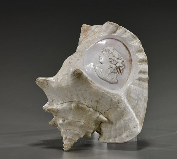 Old Cameo Carved Conch Shell: Old Cameo Carved Conch Shell Old conch shell; with cameo carved bust of a Classical beauty in toga-type clothing and with elaborately coiffed hair, wearing a grape vine wreath around her head; L: 7 1/