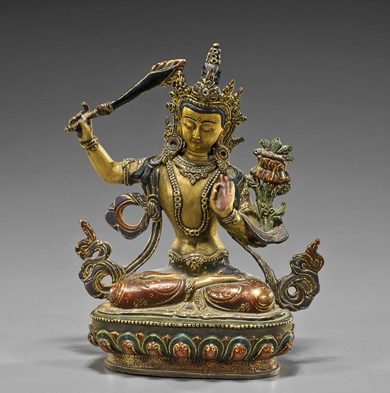 Nepalese Parcel-Gilt & Polychrome Bronze Deity: Nepalese Parcel-Gilt & Polychrome Bronze Deity Nepalese parcel gilt and polychrome bronze Buddhist deity; seated in lotus posture atop a stylized lotus pedestal and wearing elaborate clothing and head