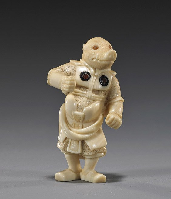 Carved Ivory Netsuke: Boar Warrior: Carved Ivory Netsuke: Boar Warrior Well carved ivory netsuke; of a warrior with boars head; standing in full armour with double inlays at the breast, inlaid eyes, signed Meizen in inlaid oval reserve
