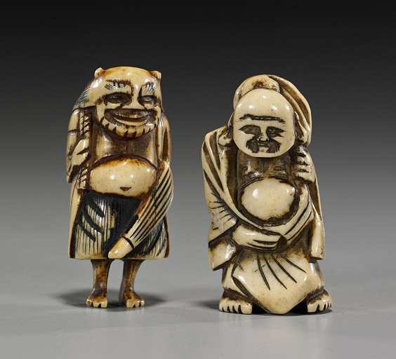 Two Antique Carved Stag Antler Netsuke: Two Antique Carved Stag Antler Netsuke Two antique carved stag antler netsuke: an oni carrying an umbrella, some inked details; together with a standing Hotei with his sack over one shoulder (usual we
