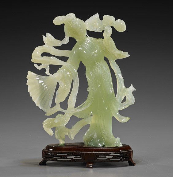 Chinese Carved Green Bowenite Beauty: Chinese Carved Green Bowenite BeautyChinese carved translucent green bowenite figure of a beauty; standing in long flowing robes and carrying a fan in one hand, a lotus in the other; H: 8 3/4", wood s