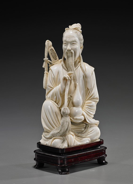 Old Chinese Carved Ivory Sage/Dignitary: Old Chinese Carved Ivory Sage/DignitaryWell carved and old, Chinese ivory figure of a bearded sage or dignitary; seated in long robes with a sword on his back, a gourd in one hand, and a whisk in the