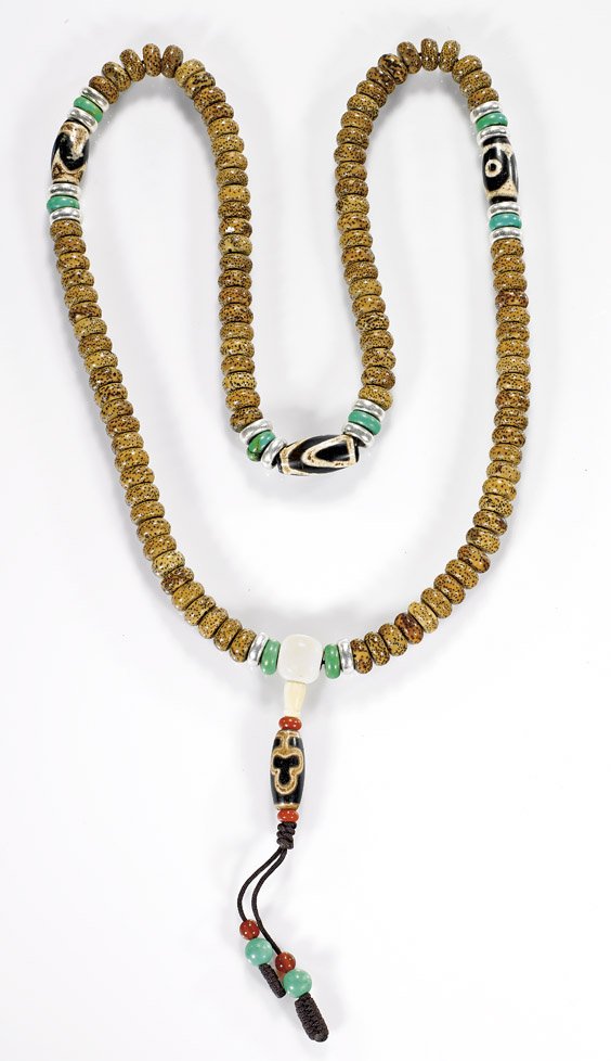 TIBETAN-STYLE BUDDHIST BEADS: TIBETAN-STYLE BUDDHIST BEADS Tibetan-style Buddhist bead necklace; comprised of polished seed roundels, with agate Dzi-type beads, metal spacers, and ivory guru bead; L: 36" (approx.) 藏傳