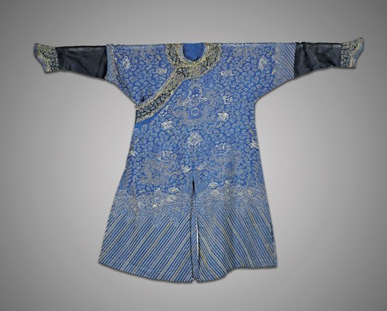 EMBROIDERED SILK BLUE DRAGON ROBE: EMBROIDERED SILK BLUE DRAGON ROBE Unusually woven, Chinese blue ground silk dragon robe; with design of three dragons to the front amid clouds, rendered in an outline fashion, and above typical lishui