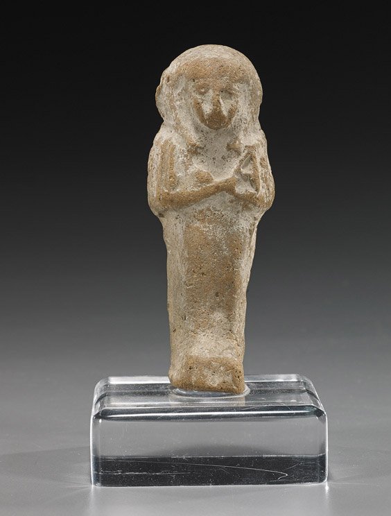 Ancient Egyptian Pottery Ushabti Figure: Ancient Egyptian Pottery Ushabti Figure Ancient Egyptian pottery ushabti figure; in usual form, standing with arms crossed at the chest and wearing a headdress (usual wear); H: 4 1/2", lucite stand