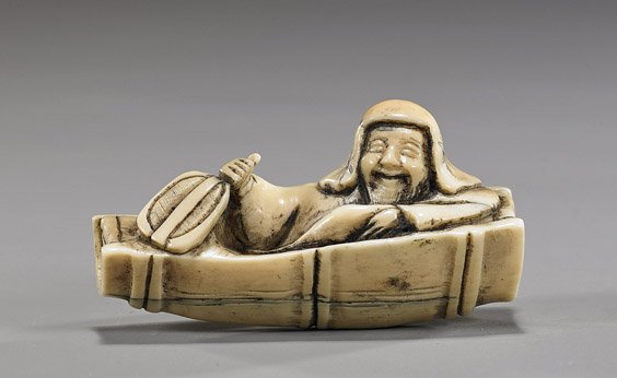 Old Carved Ivory Netsuke: Man in a Boat: Old Carved Ivory Netsuke: Man in a Boat Early 20th Century carved ivory netsuke; of a man in long robes and a hood, holding a fan and seated in a bamboo boat, signed Gyokuyoki
