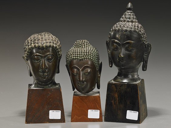 Three Antique Southeast Asian Bronze Heads: Three Antique Southeast Asian Bronze Heads Group of three antique Southeast Asian bronze Buddhist heads; the heaviest South China or Thai, the other two Thai or Burmese: each with elongated earlobes a