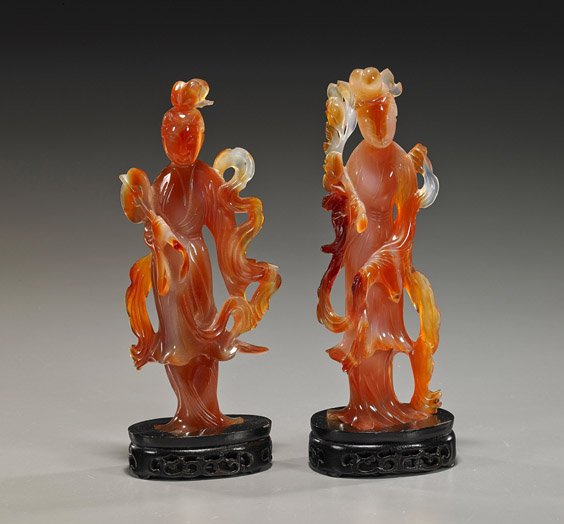 Pair Old Carved Carnelian Agate Beauties: Pair Old Carved Carnelian Agate Beauties Pair early 20th Century, Chinese carved carnelian agate figures of beauties; each standing in long flowing robes: one holding a fan; the other with a branch, f