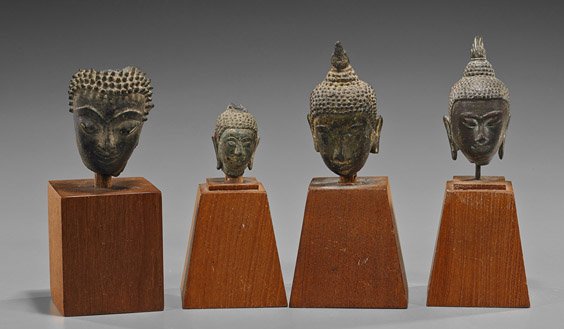 Four Antique Southeast Asian Bronze Heads: Four Antique Southeast Asian Bronze Heads Group of 4 small, antique Southeast Asian bronze Buddhist heads, including Thai and possibly Cambodian: two with some remaining gilt, two with flame ushnisha,