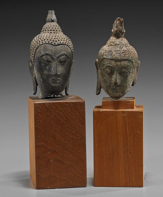 Two Antique Southeast Asian Bronze Heads: Two Antique Southeast Asian Bronze Heads Two antique Southeast Asian bronze Buddhist heads, both probably Thai; each with serene expression to the face, elongated earlobes, and flame ushnishas (one he