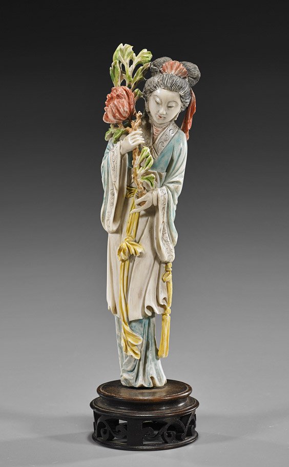 Chinese Carved & Polychrome Ivory Beauty: Chinese Carved & Polychrome Ivory BeautyEarly 20th Century, Chinese carved and polychromed ivory beauty; standing in long robes and carrying a branch with blossom; H: 9"