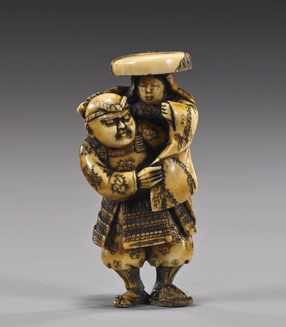 Antique Ivory Netsuke: Samurai & Woman: Antique Ivory Netsuke: Samurai & Woman Antique carved ivory netsuke; of a Samurai standing and carrying aloft a lady with a wide-brimmed hat (repair to left foot), signed Gyokusan
