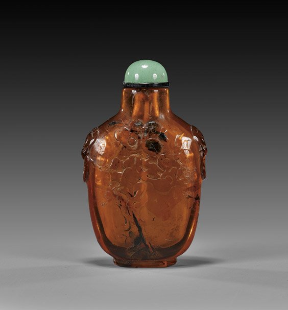 CARVED NATURAL AMBER SNUFF BOTTLE: CARVED NATURAL AMBER SNUFF BOTTLE Finely hollowed, transparent natural amber snuff bottle; of flattened, slightly tapered form, with low relief carved monkey and tree design to the front, and with fau