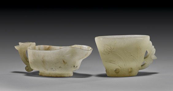 TWO ANTIQUE CHINESE CARVED COUPES: TWO ANTIQUE CHINESE CARVED COUPES Two antique Chinese carved coupes: the larger of translucent celadon jade with slight russet rivering, with cherry blossom branches in light relief and hydra handle; 