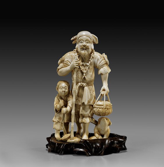 ANTIQUE JAPANESE IVORY OKIMOMO: ANTIQUE JAPANESE IVORY OKIMOMOVery finely detailed and animated, antique Japanese ivory okimono: of a man with bamboo staff, and basket of fish; a young boy beside him also carrying fish, with a puppy