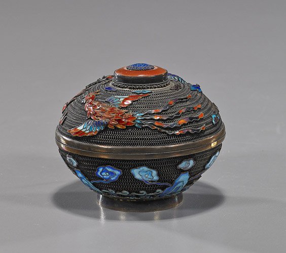 Chinese Silver Filigree & Enameled Box: Chinese Silver Filigree & Enameled Box Chinese silver filigree and enamel box; of small circular form with dragon and phoenix designs above waves, the top with red jadeite or carnelian bead finial; D: