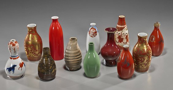 Twelve Old & Antique Asian Ceramic Vases: Twelve Old & Antique Asian Ceramic Vases Group of 12 old and antique Chinese and Japanese bottle form vases and sake bottles, various types and glazes, including: coral red, Kutani, one with lid, one 