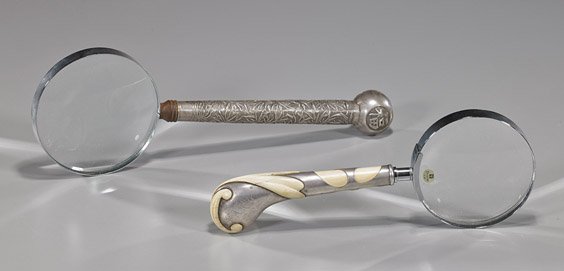 Two Silver Handled Magnifying Glasses: Two Silver Handled Magnifying Glasses Two magnifying glasses; each with silver handle: larger Chinese Export repoussé with bamboo design and characters, maker's mark; together with ivory mounted, eng