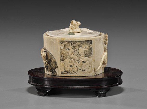 Antique Japanese Carved Ivory Tiger Box: Antique Japanese Carved Ivory Tiger Box Antique Japanese carved ivory box; oval with numerous animals in relief, the mis-matched cover carved with a tiger in low relief and tiger finial, and set with 