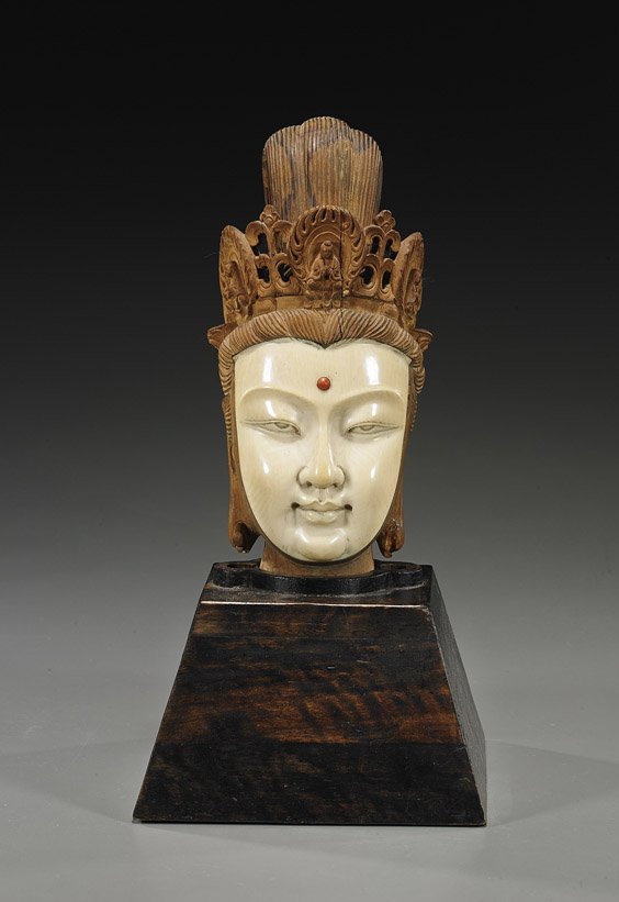 Old Chinese Wood & Ivory Head of Guanyin: Old Chinese Wood & Ivory Head of GuanyinEarly 20th Century, Chinese carved head of Guanyin: sectional using hardwoods and the face in ivory; coral cabochon "jewel" to the forehead, wearing an elaborat