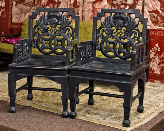 Pair Chinese Hardwood Armchairs: Pair Chinese Elm wood ArmchairsPair Chinese hardwood elm wood armchairs; each with openwork bat and coin designs to the backs and arms (usual wear), early 20th Century; H: 38" (each)