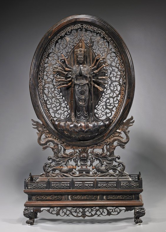 Chinese Hardwood Buddhist Sculpture/Screen: Chinese Hardwood Buddhist Sculpture/Screen Very elaborately carved, Chinese hardwood Buddhist sculpture/screen: with a multi-armed deity standing on a lotus pedestal and with hands holding various rit