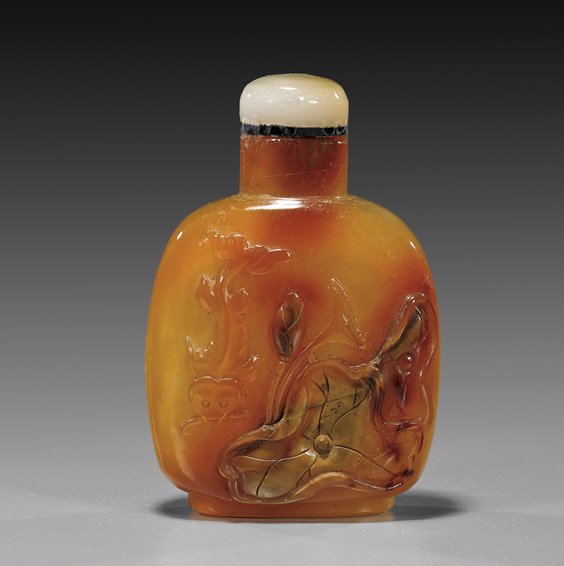 Chinese Cameo Agate Snuff Bottle: Chinese Cameo Agate Snuff Bottle Finely hollow, Chinese cameo carved carnelian agate snuff bottle; with design of lotus and a swimming carp to the front, white jade or agate stopper; H: 3"