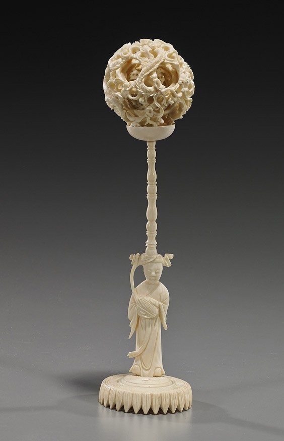 Chinese Carved Ivory Concentric Puzzle Ball: Chinese Carved Ivory Concentric Puzzle Ball Chinese carved ivory puzzle ball; with at least 9 interior concentric balls: the exterior with openwork design of writhing dragons among clouds, ivory pedes