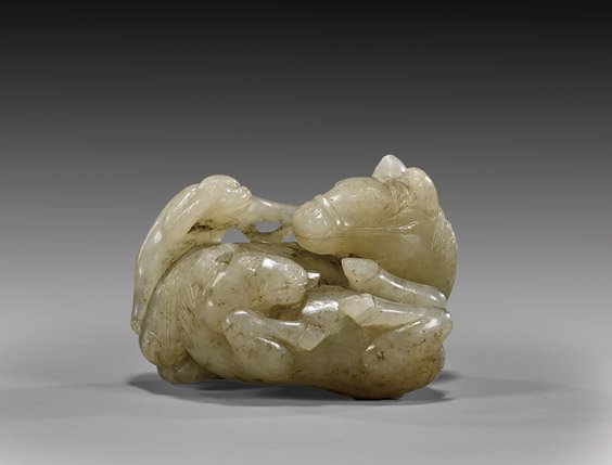 CARVED WHITE JADE TOGGLE: Two Horses: CARVED WHITE JADE TOGGLE: Two HorsesCharming Chinese carved white jade toggle; in form of two horses: a recumbent adult with a monkey on its back, the playful young flipped over; probably antique; L: