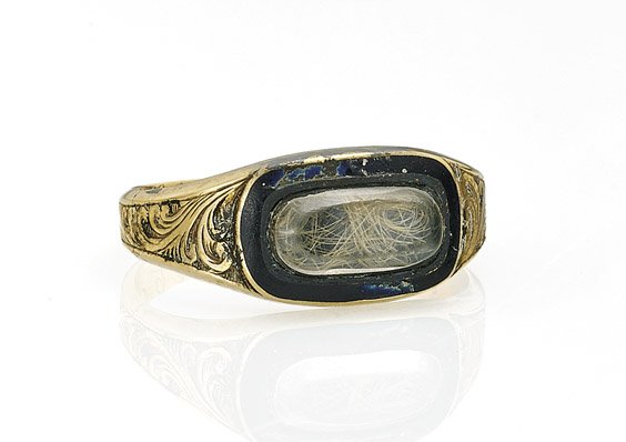 ANTIQUE (EARLY) AMERICAN YELLOW GOLD RING: ANTIQUE (EARLY) AMERICAN YELLOW GOLD RINGAntique American yellow gold ring; set with a lock of hair beneath a clear glass cabochon, encircled with band of enameling, and engraved with foliate scrollin