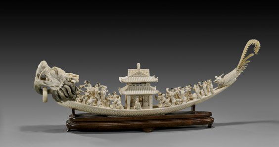 OLD CARVED IVORY DRAGON BOAT: OLD CARVED IVORY DRAGON BOATVery intricately carved and finely detailed, early 20th Century, Chinese ivory dragon boat; depicting a celebratory scene of with numerous figures on board, mostly celestia
