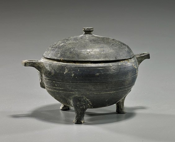 Chinese Han Dynasty Black Pottery Censer: Chinese Han Dynasty Black Pottery Censer Chinese Han Dynasty archaic black pottery censor with cover; globular form on tripod feet with two small rectangular handles and domed cover; D: 6 1/2", lucite