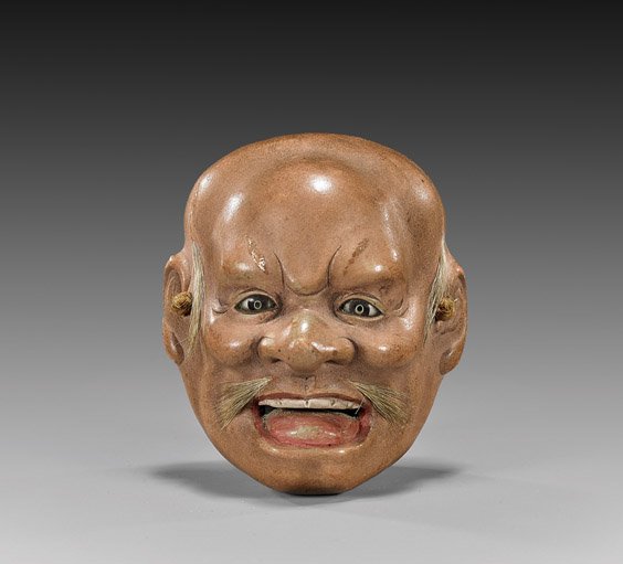 Large Antique Lacquer Mask Netsuke: Large Antique Lacquer Mask Netsuke Antique large lacquered mask netsuke; naturalistic with inlaid glass eyes and horse hair mustache, late 19th Century; L: 2 1/2"