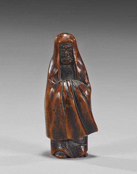 Antique Carved Wood Figural Netsuke: Antique Carved Wood Figural Netsuke Antique carved wood netsuke; of a standing Daruma in long robes and veil, with arms folded in front (crack to back, old chips to foot); Provenance EX: Raymond Bushe