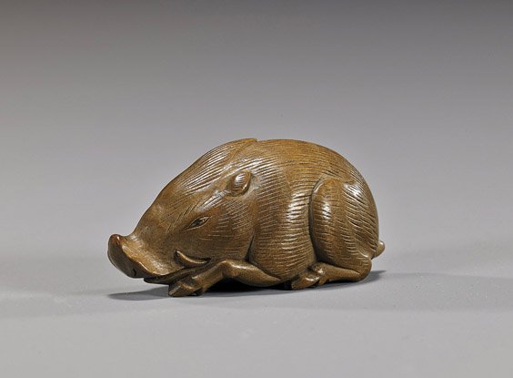 Antique Carved Boxwood Netsuke: Boar: Antique Carved Boxwood Netsuke: Boar Well detailed and antique, carved boxwood netsuke; of a reclining boar (small natural fissure to wood), late 19th Century; Provenance EX: Raymond Bushell Collectio