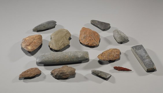 Group of 13 Early Man Stone Hand Tools: Group of 13 Early Man Stone Hand Tools Group of 13 Early Man stone hand tools, including: axe heads, scrapers, etc., and a red spear head; from various locations worldwide; L: 7" (longest)