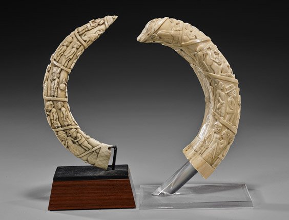 Two Antique African Carved Ivory Hippo Tusks: Two Antique African Carved Ivory Hippo Tusks Two very elaborately carved, antique African ivory hippo tusks: each with many figures continuously scrolling the full length, some in Western clothes; L: 