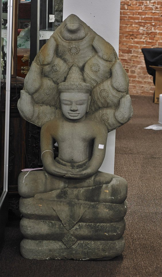 Massive Southeast Asian Carved Sandstone Figure: Massive Southeast Asian Carved Sandstone Figure Massive Southeast Asian carved sandstone Buddhist figure: seated in lotus posture atop the body of a coiled snake, with hands in mudra and with large Na