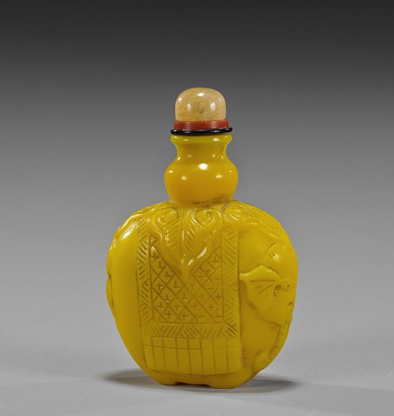 Chinese Carved Yellow Glass Snuff Bottle: Chinese Carved Yellow Glass Snuff Bottle Unusual old Chinese carved, Imperial-type yellow glass snuff bottle; in the form of a caparisoned elephant, quartz crystal stopper; H: 2 1/2"