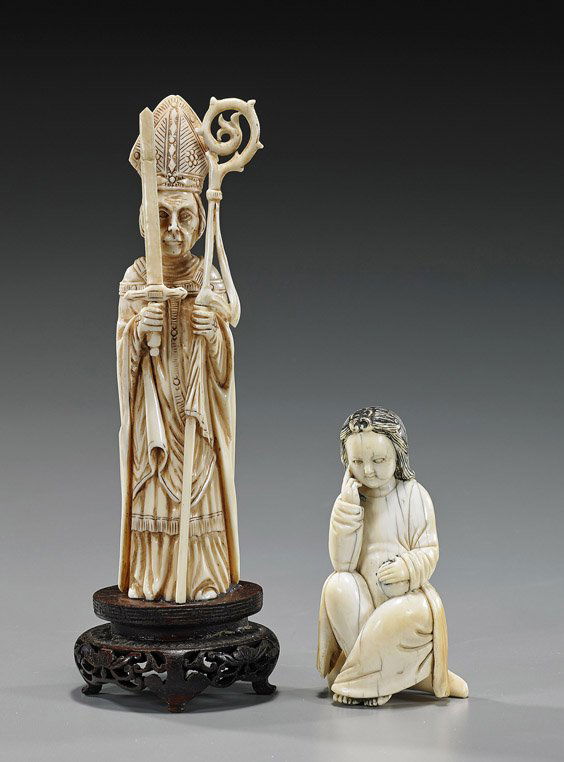 Two Continental Carved Ivory Figures: Two Continental Carved Ivory FiguresTwo Continental carved Ivory figures: a standing Bishop in long robes and miter cap, carrying a staff in one hand, a sword in the other (repair to sword); and a fig