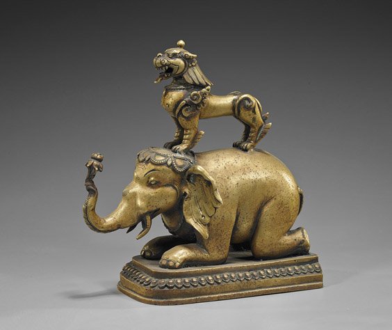 Antique Indian or Nepalese Bronze Elephant: Antique Indian or Nepalese Bronze Elephant Antique Indian or Nepalese bronze elephant; kneeling and carrying a lotus blossom in its raised trunk, with a lion standing on its back (possible loss to rea