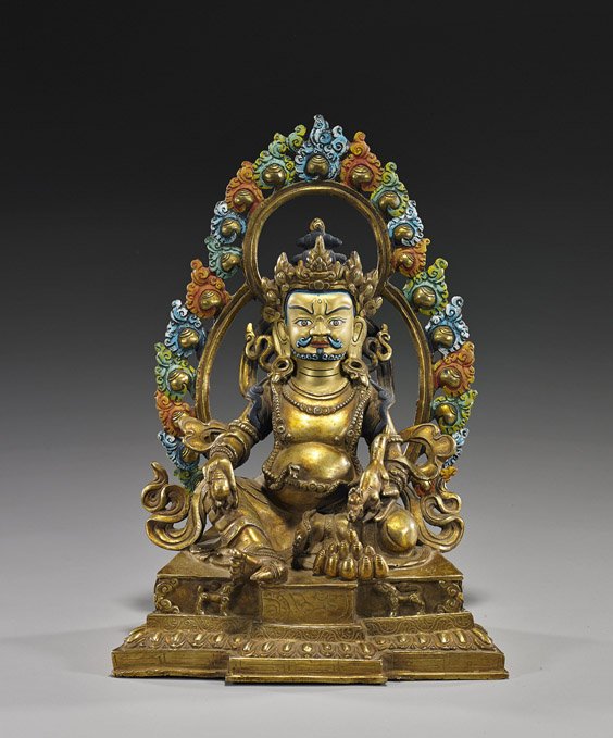 Elaborate Nepalese/Tibetan Gilt Bronze Deity: Elaborate Nepalese/Tibetan Gilt Bronze DeityElaborately cast Nepalese or Tibetan gilt bronze model of the deity Kubera; seated on a raised pedestal, wearing an elaborate crown and with a conch shell i