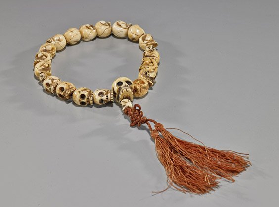 Antique Tibetan Carved Bone Skull Beads: Antique Tibetan Carved Bone Skull BeadsAntique Tibetan carved bone beads necklace; each carved as a skull and strung together with a tassel; L: 12"
