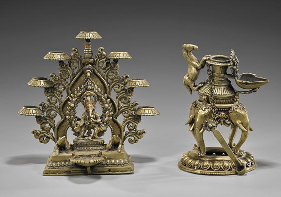 Two Indian or Nepalese Bronze Vessels: Two Indian or Nepalese Bronze Vessels Two antique Indian or Nepalese bronze temple vessels: seven light with Ganesha flanked by two animals; together with a horse handled form on elephant design raise