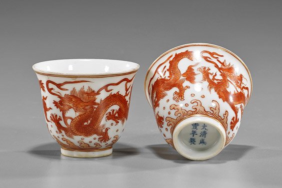 Pair Coral Red Dragon Porcelain Wine Cups: Pair Coral Red Dragon Porcelain Wine Cups Pair of Chinese, late Qing-style cups; each with coral red writhing dragons above waves, 6-character marks (usual wear to both); D: 2 3/8" (each)