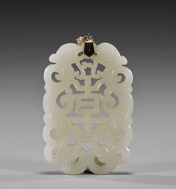 Antique Chinese Carved White Jade Pendant: Antique Chinese Carved White Jade PendantAntique Chinese, openwork carved white jade pendant; in the form of a Shou character flanked by scrolling dragons, with 14K yellow gold bail; L: 2 1/2" (pendan