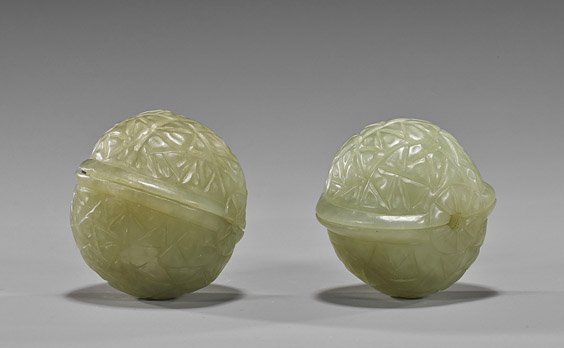 Pair Chinese Carved Celadon Jade "Walnuts": Pair Chinese Carved Celadon Jade "Walnuts" Pair Chinese carved celadon jade baoding balls; in the form of walnuts with geometric designs; D: 1 1/2"