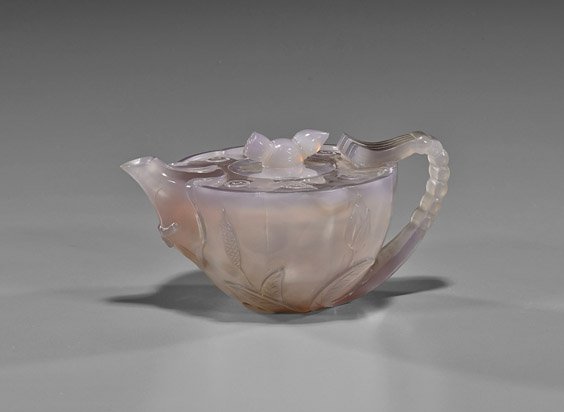 Unusual Chinese Carved Chalcedony Teapot: Unusual Chinese Carved Chalcedony TeapotUnusual and nearly transparent, Chinese carved grey chalcedony agate teapot; of lotus form, well hollowed and with matching cover; L: 5 3/4"