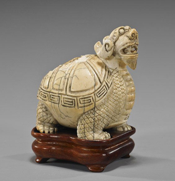Old Chinese Carved Ivory Dragon Turtle: Old Chinese Carved Ivory Dragon TurtleOld Chinese carved ivory model; in the form of a dragon turtle, archaistic facial detailing and on shell (cracks and crazing); L: 4"